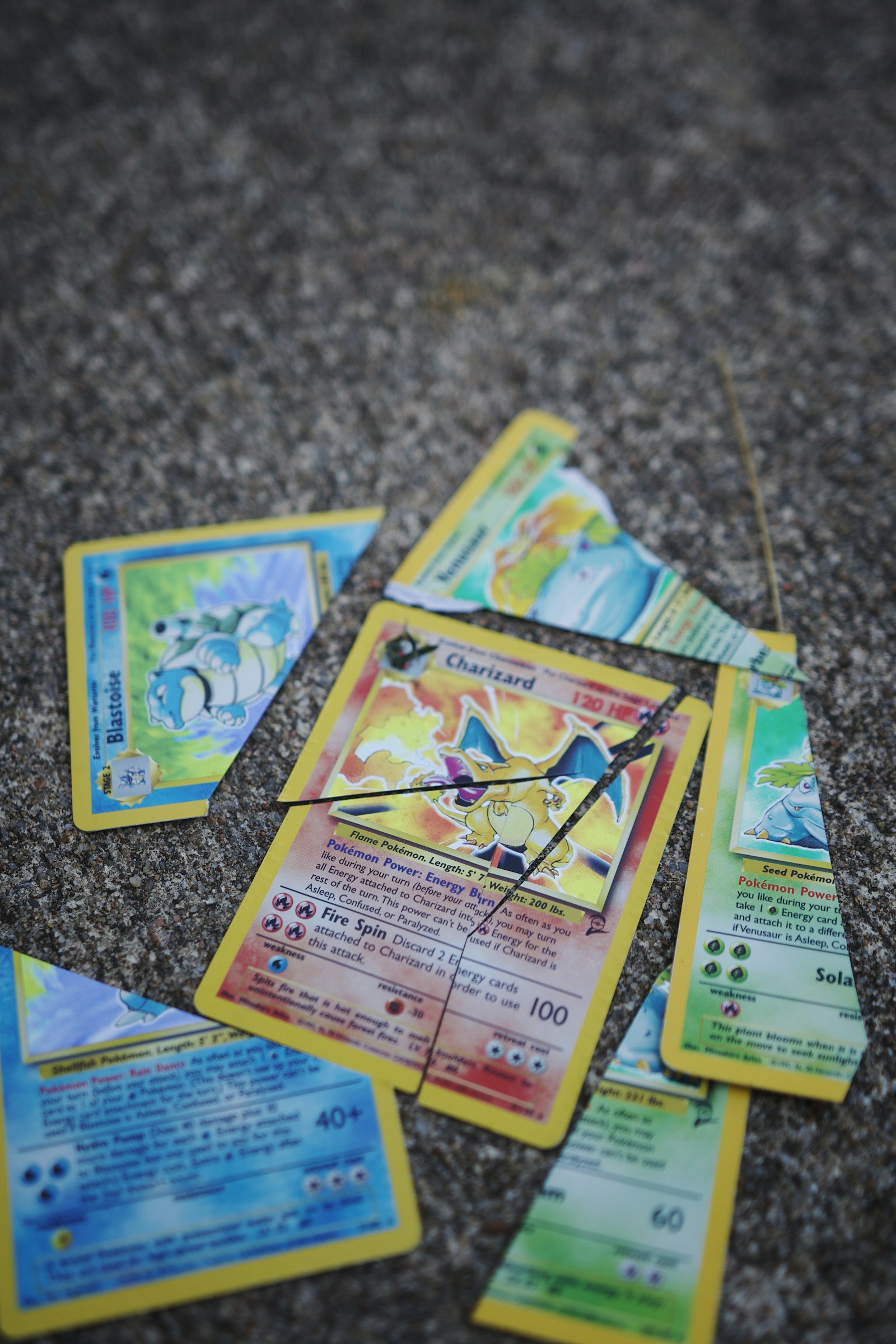 A vintage Charizard Base Set card lying among other old Pokémon cards